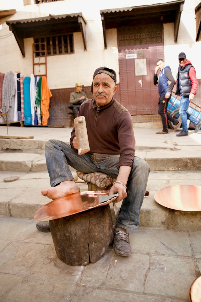 Senior Man Making a Copper Tray at a Bazaar in Morocco Fez