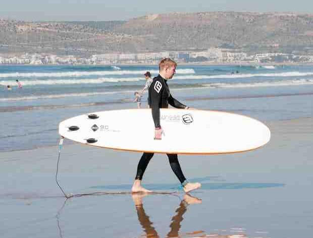 Surfer holding a surf board in Agadir