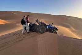 Touists next to quad bikes in Merzouga